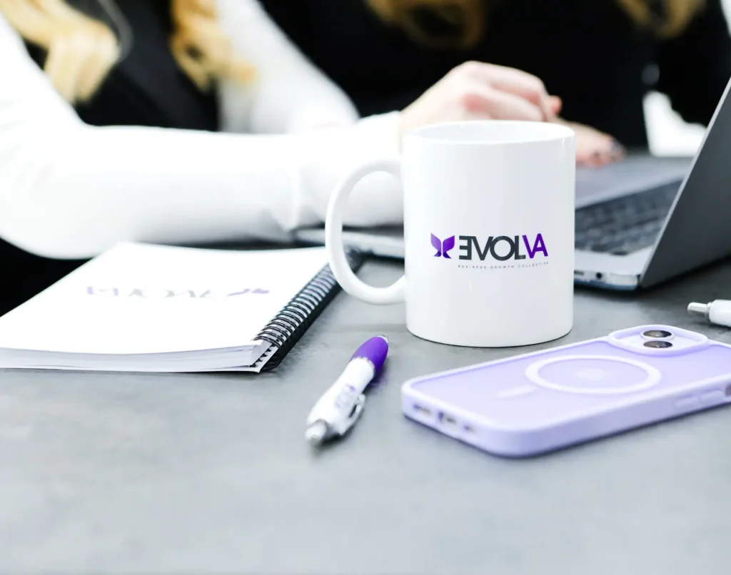 Evolva branding including mugs, notepad and pen.