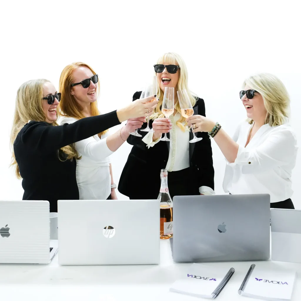 The Evolva Business Growth Collective team celebrating with drinks.