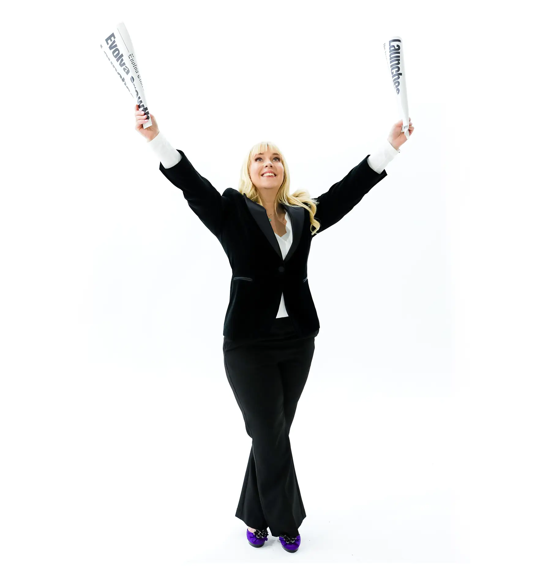 Evolva Founder Kellie holding two launch newspapers.